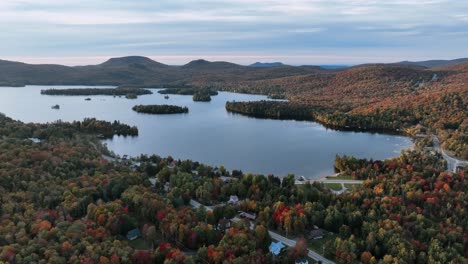 Aerial-View-Over-Blue-Mountain-Lake-Surrounded-With-Lush-Vegetation-And-Mountains-In-New-York,-United-States---Drone-Shot