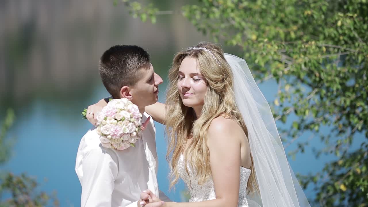 Wedding Couple In Love. Elegant gentle stylish groom and bride near river with stones