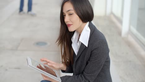 calm professional woman using tablet