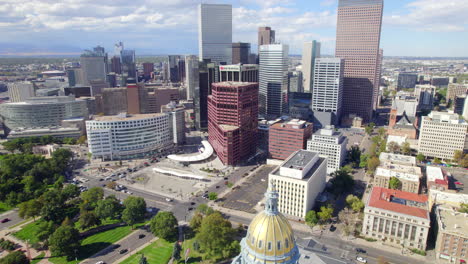 aerial drone tilt reveal of the colorado state capital government building with the skyline of downtown denver colorado in the background