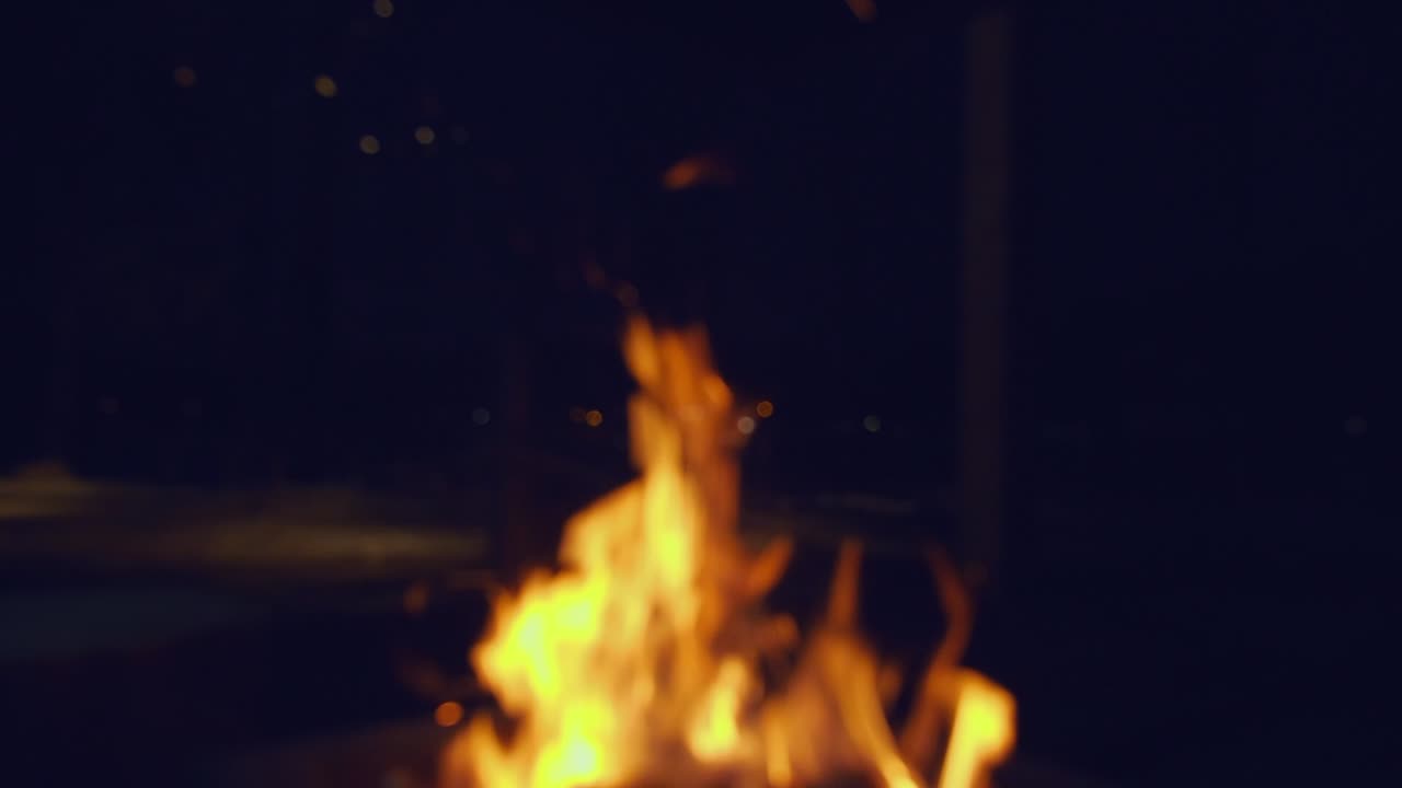 Defocused bonfire at night creates cozy outdoor background, copyspace