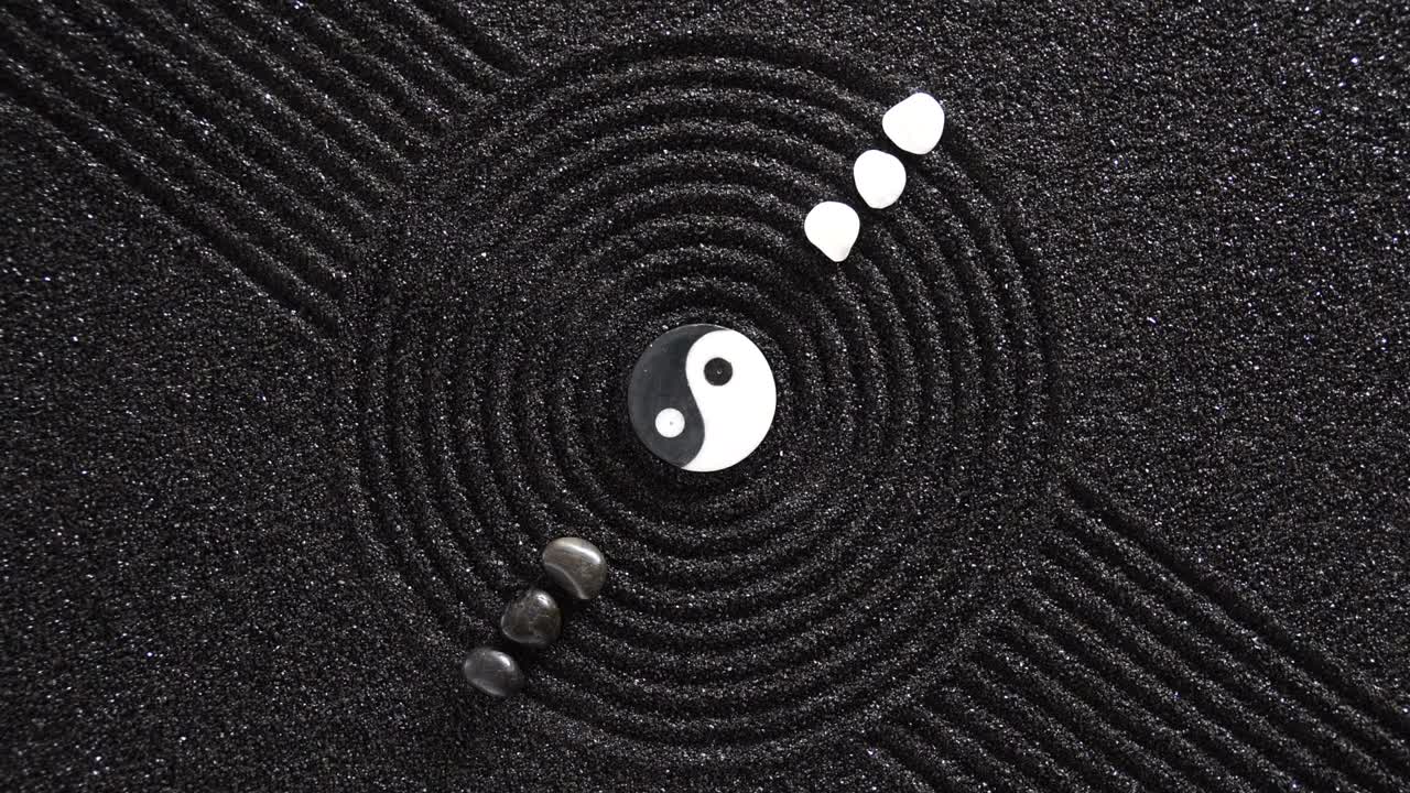 Japanese garden with yin yang stones laying in textured sand