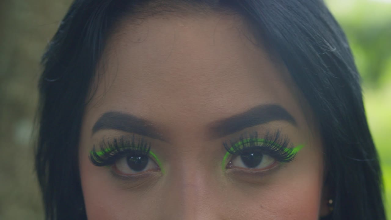 Amazing close up of a woman eyes with green highlight makeup