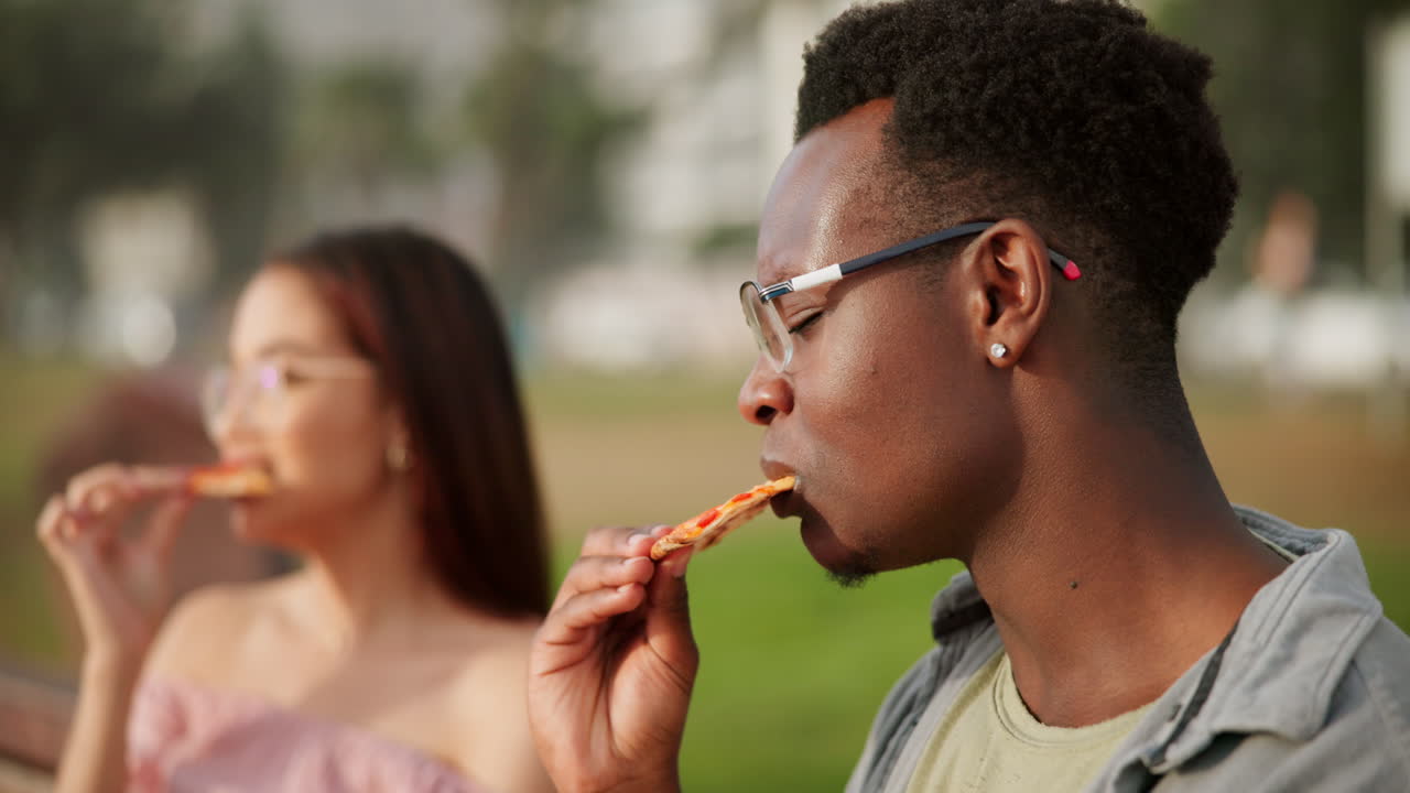 People eating pizza outdoors
