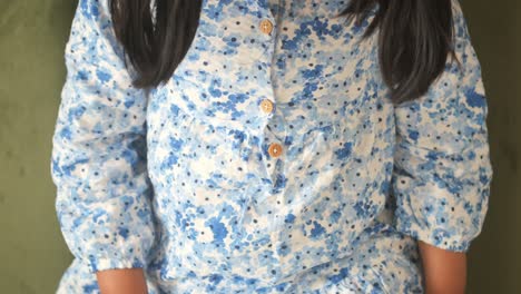 adorable little girl in a blue floral dress