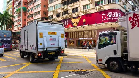 traffic and pedestrians in bustling hong kong street