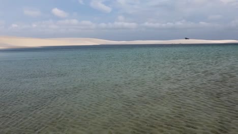 panning shot of the expansive rainwater lagoons in lencois maranhenses