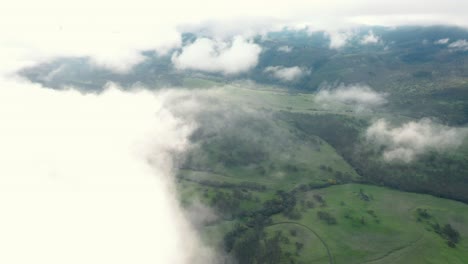 aerial footage of drone flying through and emerging from clouds in the sky