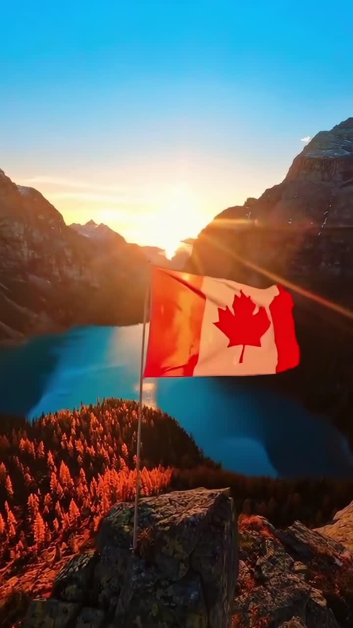 Bandiera canadese che sventola su una cima di montagna al tramonto sopra un lago