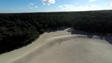 aerial footage of people on a sand hill