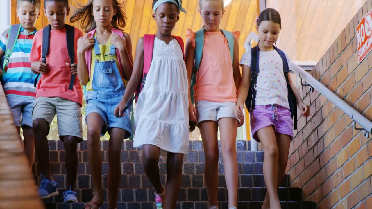 Group of kids getting down from staircase