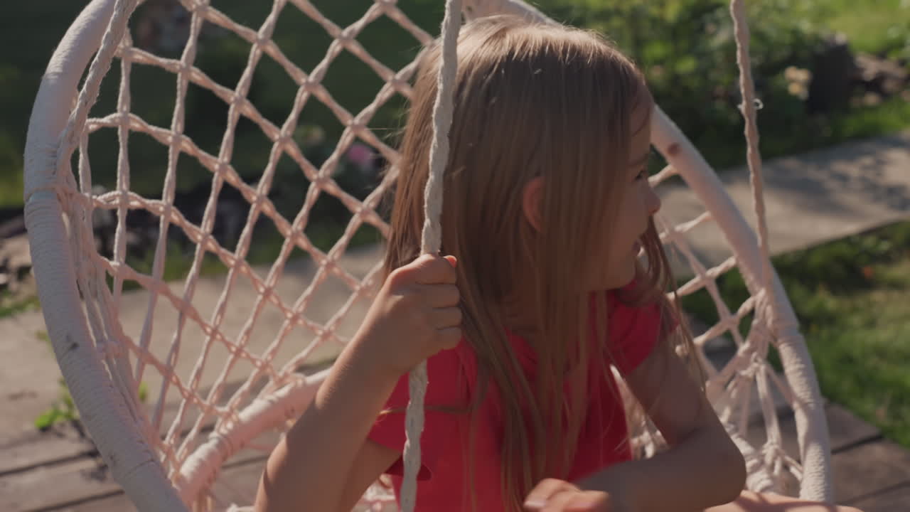 Child Explores Outdoors, Young Girl Roams Sunny Backyard, Small Child Enjoys Playing In Bright Outdoor Environment, Young Girl Explores Cheerful Backyard Filled With Sunlight And Curiosity
