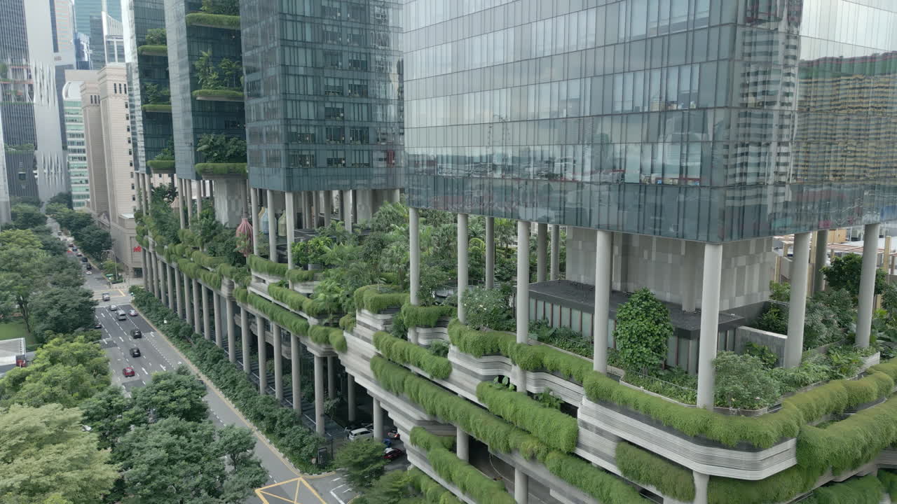 Aerial dolly shot of a green high rise, ParkRoyal is a iconic eco friendly and stunning hotel in-a garden concept that incorporates energy saving features and environmentally friendly technologies