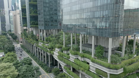 aerial dolly shot of a green high rise, parkroyal is a iconic eco friendly and stunning hotel in-a garden concept that incorporates energy saving features and environmentally friendly technologies