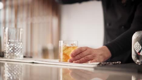 bartender pouring a cocktail