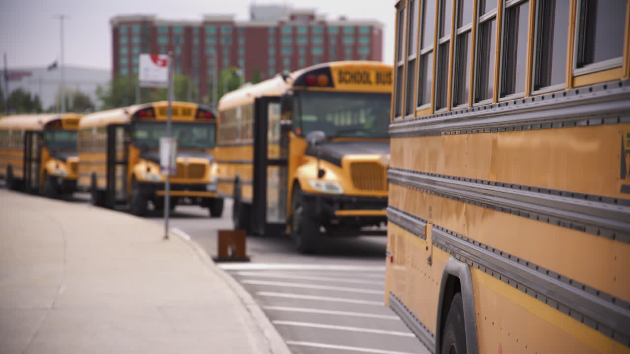 Panning shot of a line of school busses