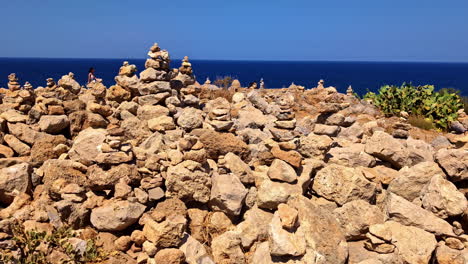 many pebble stones balanced near coastline of crete