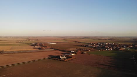 aerial dolly shot of a wind turbine and a landscape
