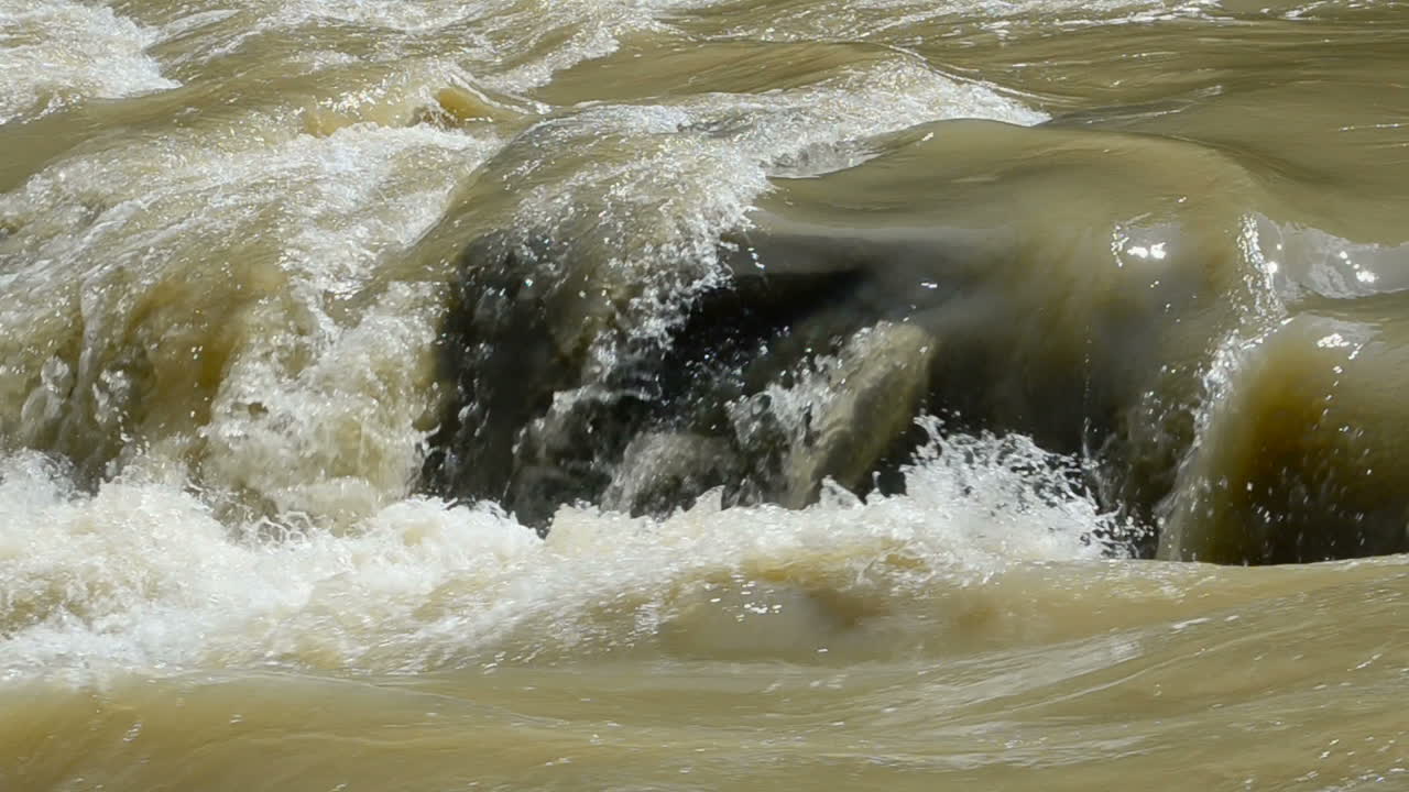 Water in the river. Slow motion. Current of the mountain river