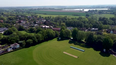 an aerial view of a real village cricket ground in kent