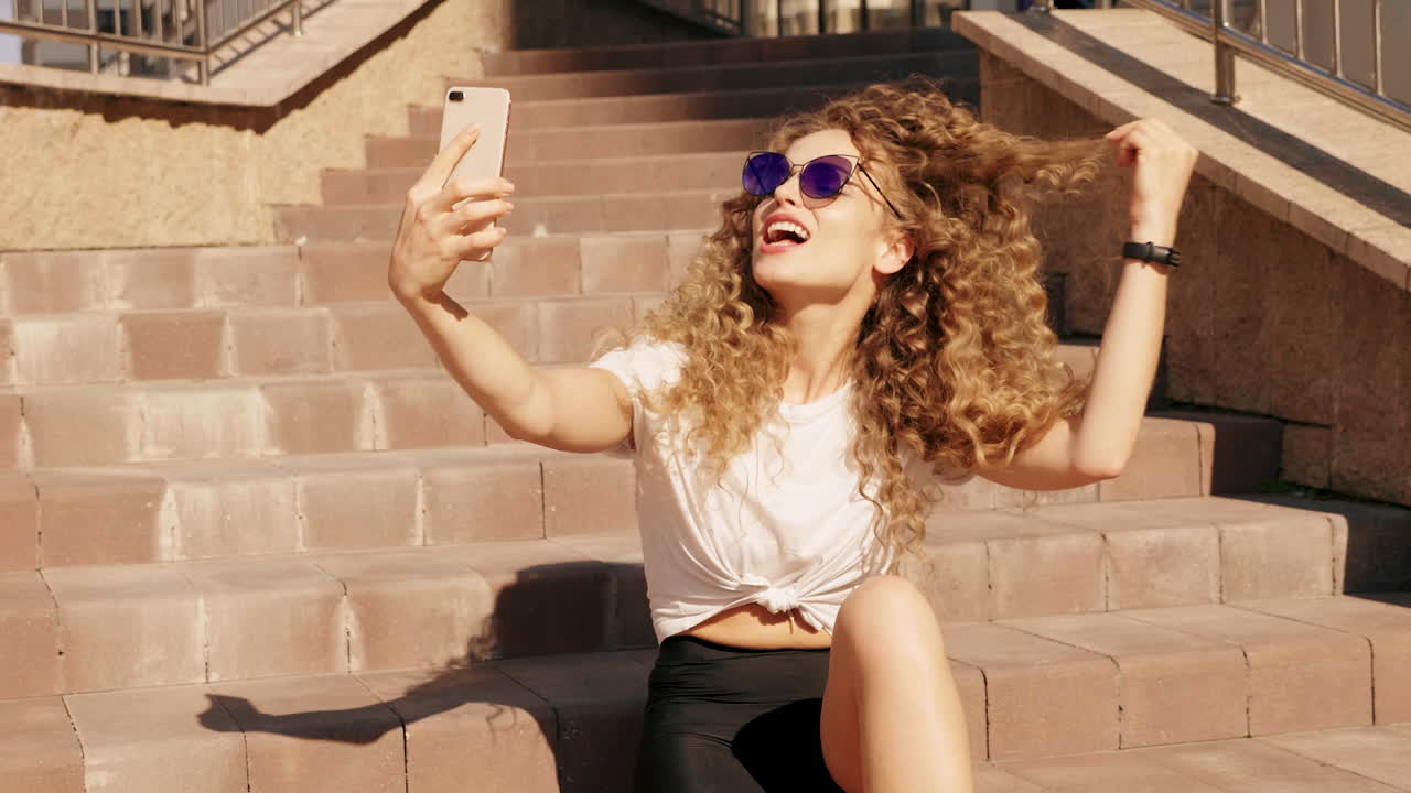 Woman taking a selfie on stairs
