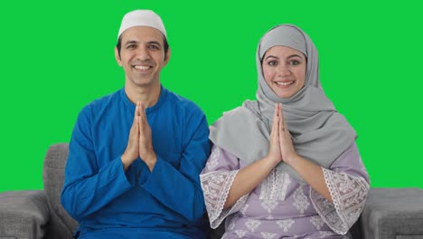 happy muslim couple doing namaste green screen