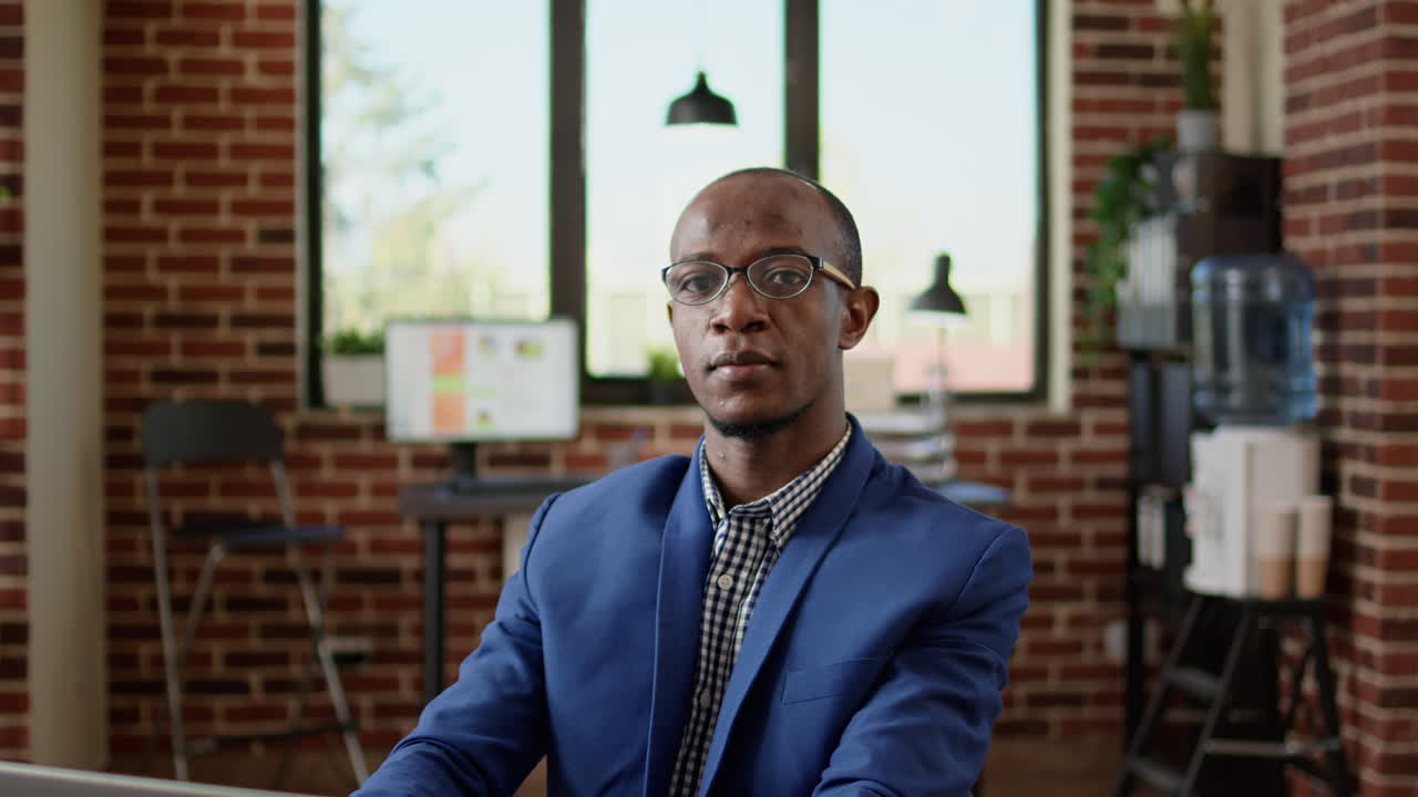 Portrait of businessman using laptop to browse internet in startup office