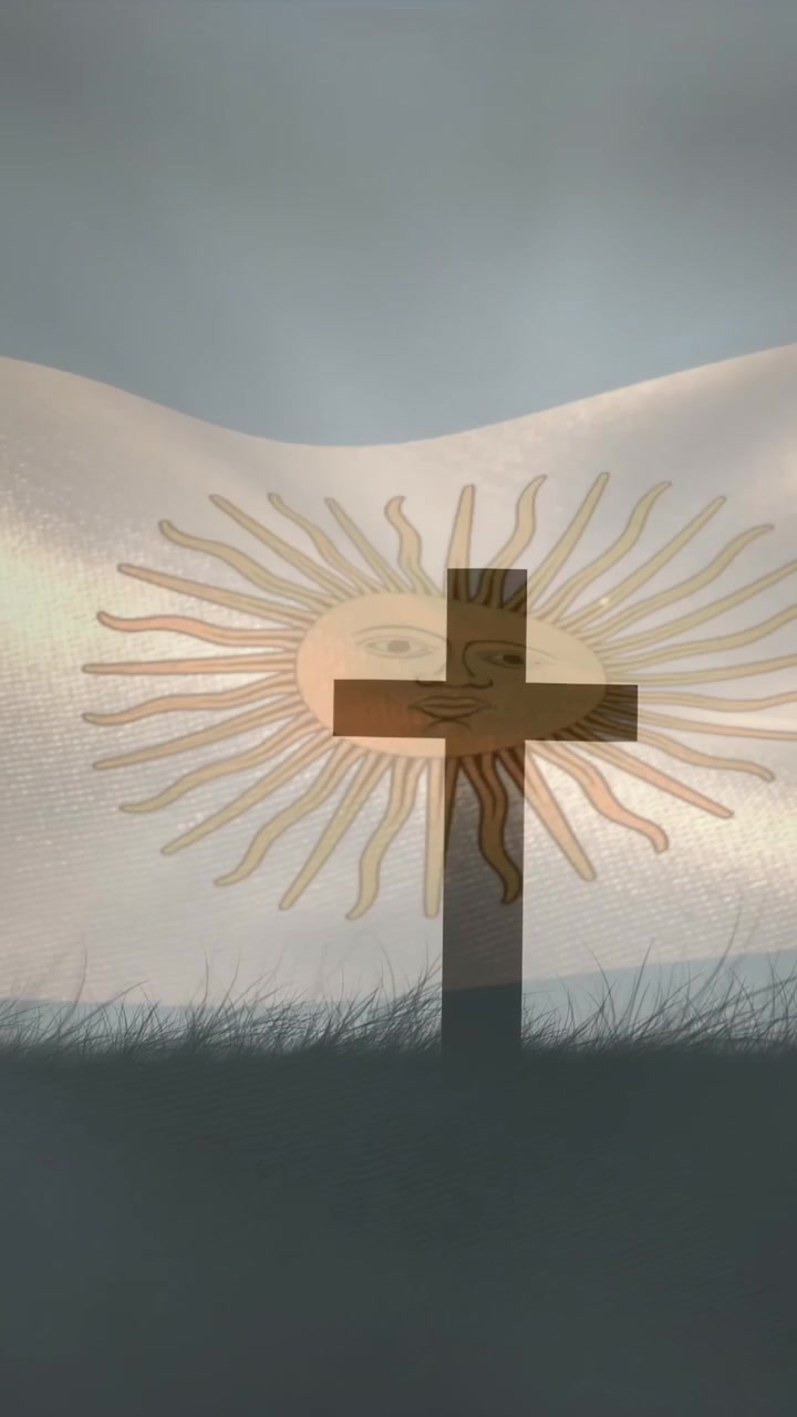 Video verticale: raffiche di vento spingono una bandiera che sventola, un emblema del sole rimane al centro mentre una croce scura si sposta.