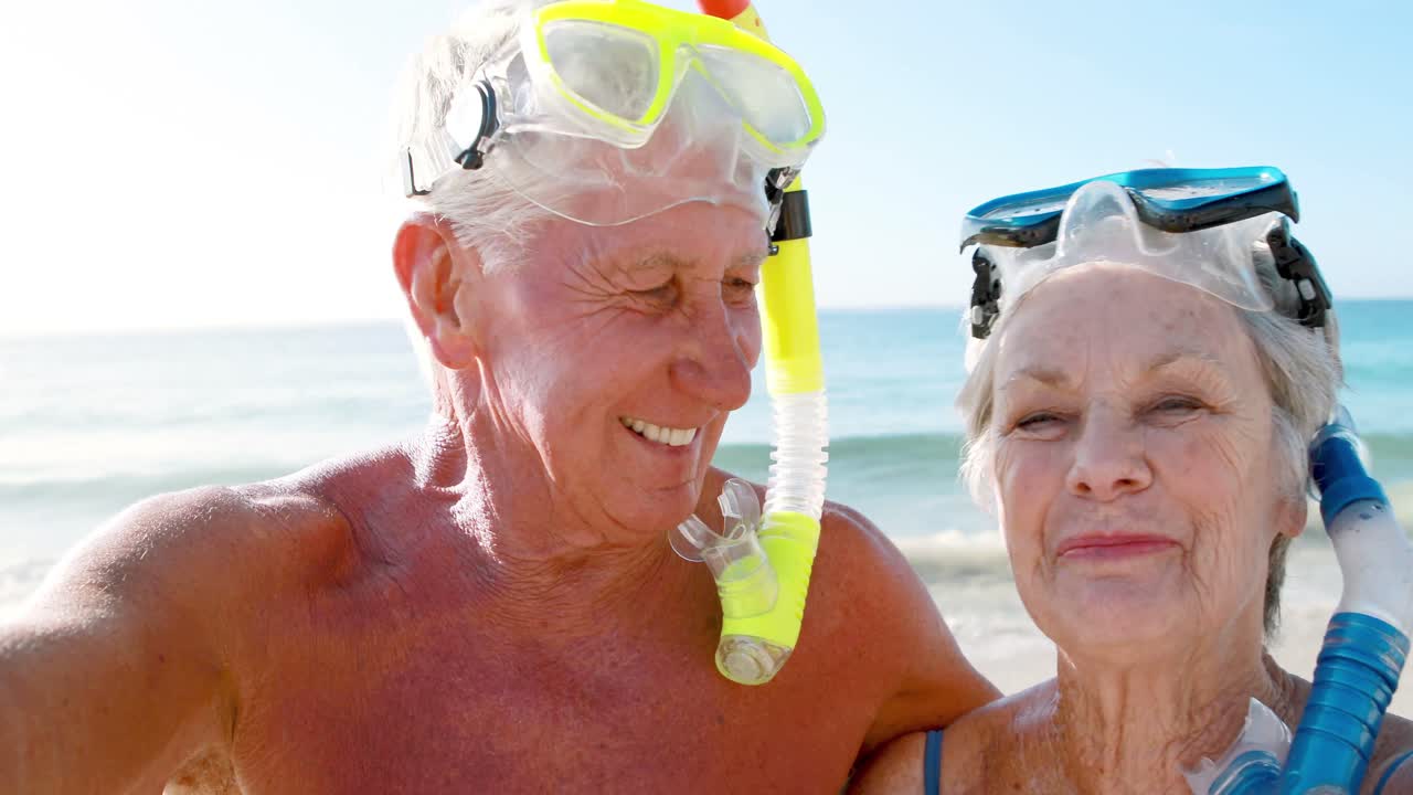 Smiling old retired couple with mask and snorkel