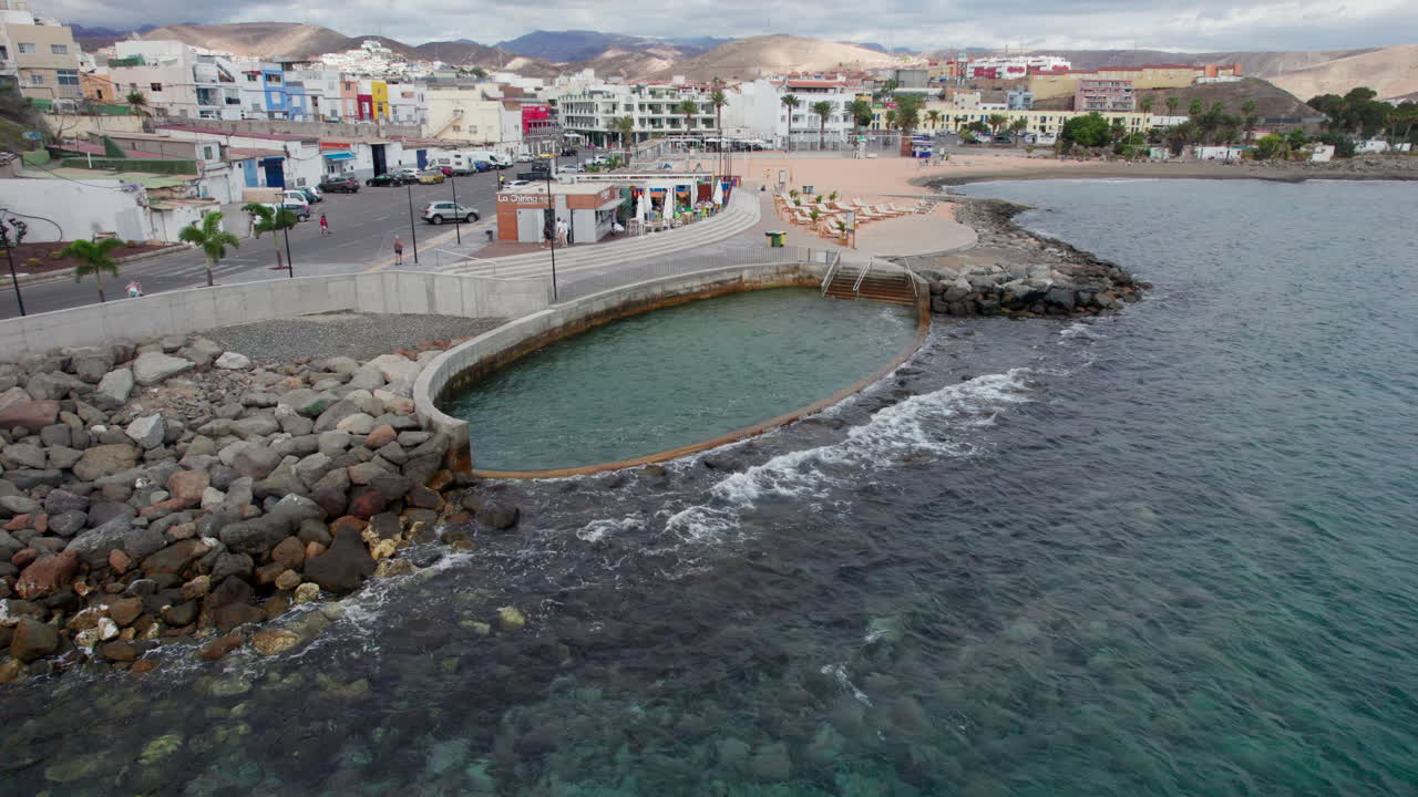vista aérea lateral de la playa de el perchel, su piscina natural y los restaurantes costeros