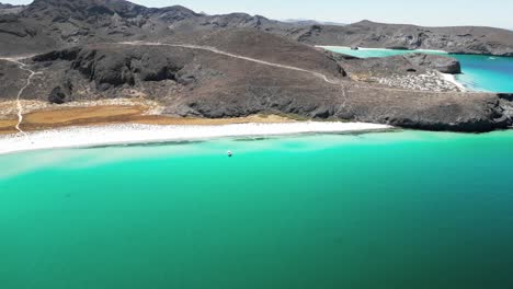 serene beach view of tecolotito, la paz, with clear turquoise waters and mountains