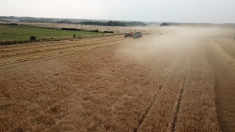 a cinematic 4k drone shot of two tractors working on a field in france, showcasing agriculture with an epic view and dramatic dust