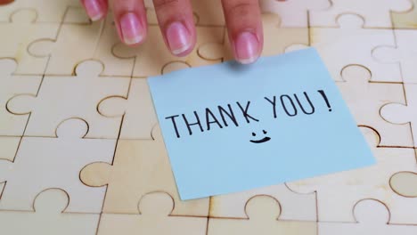 a heartfelt thank you note placed on a puzzle symbolizing appreciation in a cozy home environment
