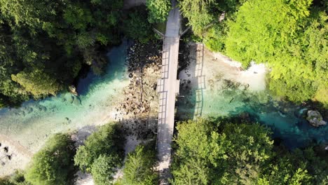 two people crossing with bike on a footbridge in a nature space in slovenia