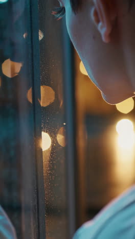 Person Looking Out a Window at Night