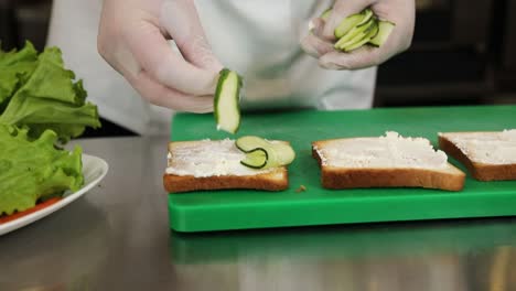 chef preparing cucumber and cheese sandwiches