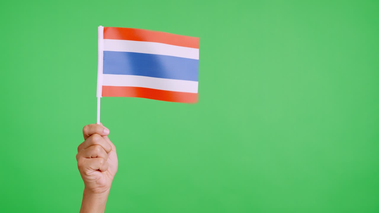 Wind waving a thai pennant holding by a person