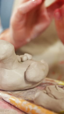 mother and daughter making a toy from clay