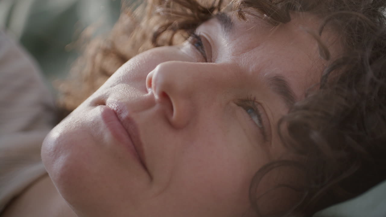 Close-up of a Woman's Face Sleeping and Waking Up