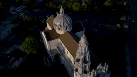 aerial view of a historic cathedral and the los angeles cityscape