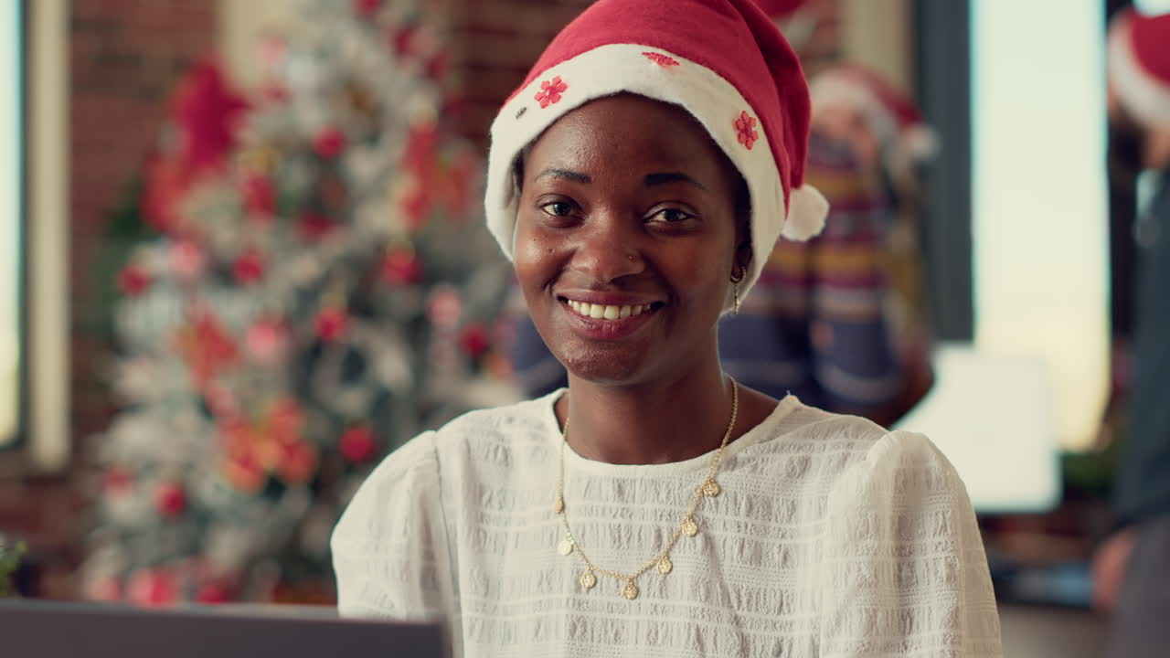 Portrait of festive woman working on laptop during winter season