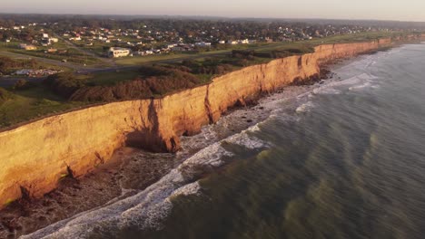 panning aerial view along los acantilados during sunset