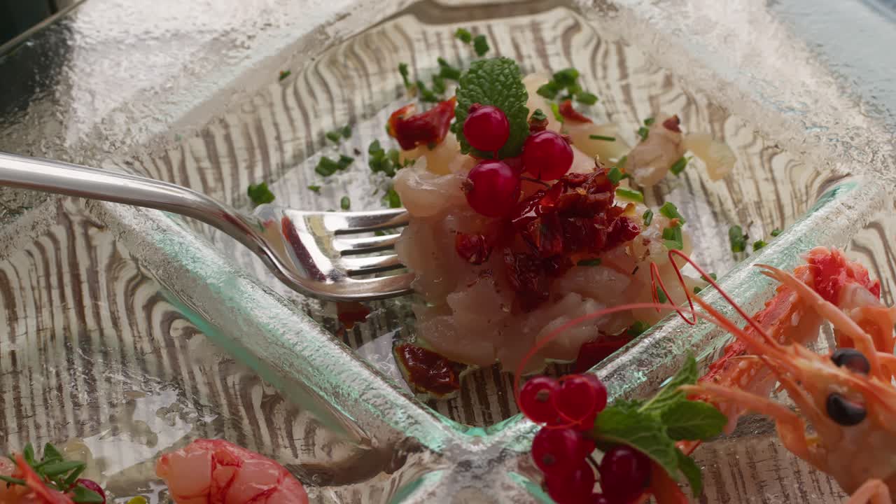 A fork picking up a colorful Mediterranean snack from an aperitif plate, showcasing vibrant and tasty food in Taormina, Sicily, Italy (Taormina, Sicilia, Italia)
