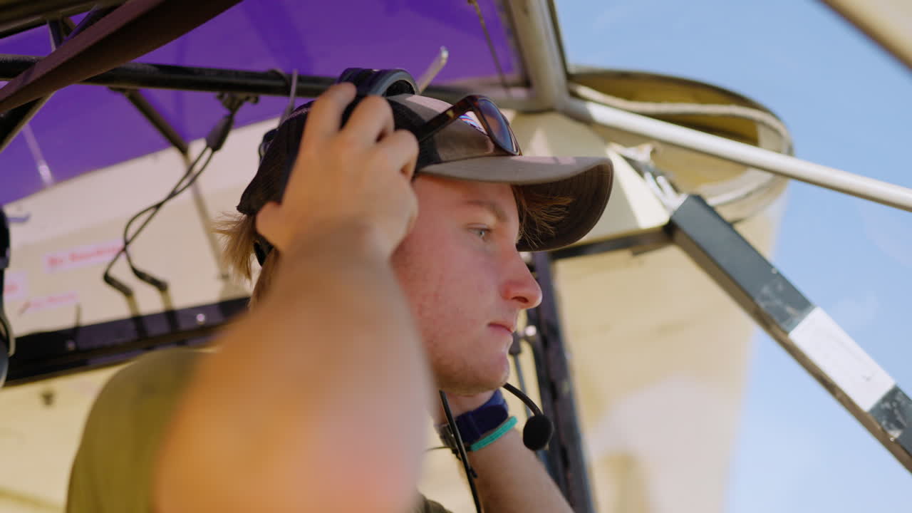 Young Pilot Puts on Headset and Prepares for Flight
