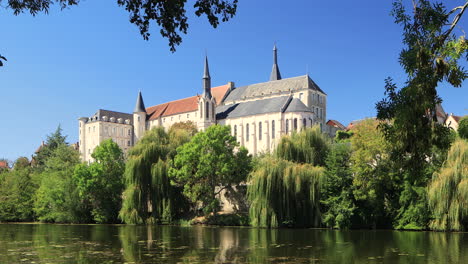 The-beautiful-former-Romanesque-priory-in-the-town-of-Saint-Gaultier-on-the-banks-of-the-river-Creuse-in-Indre,-France