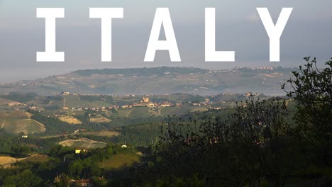 aerial drone shot of villages and mountains in italy with animated graphic spelling out italy