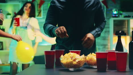 young man taking chips from the table