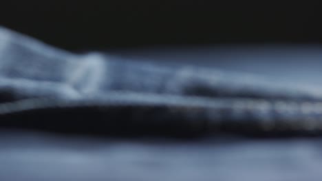 panning shot of denim fabric during manufacturing process of designer clothes in sweatshop