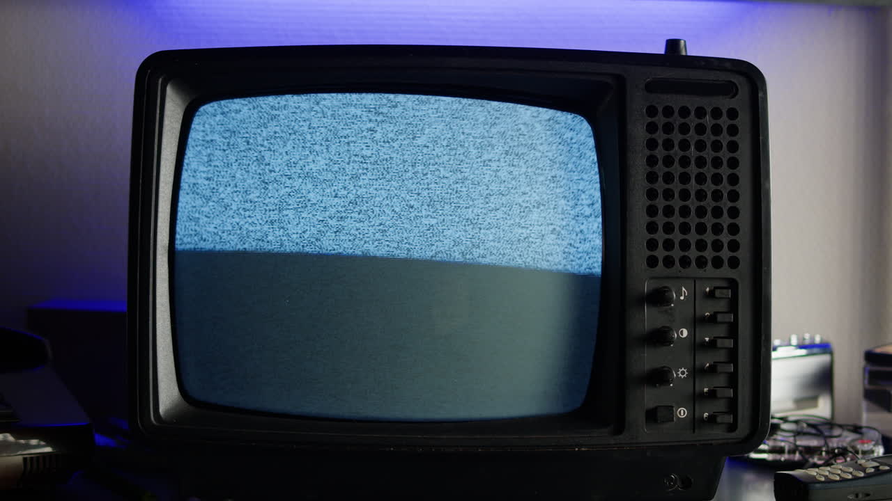 Retro TV, vintage television In a nostalgic setup, a retro TV displays grain on screen, scary halloween night device good for chroma key and green screen.