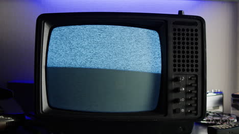 retro tv, vintage television in a nostalgic setup, a retro tv displays grain on screen, scary halloween night device good for chroma key and green screen.